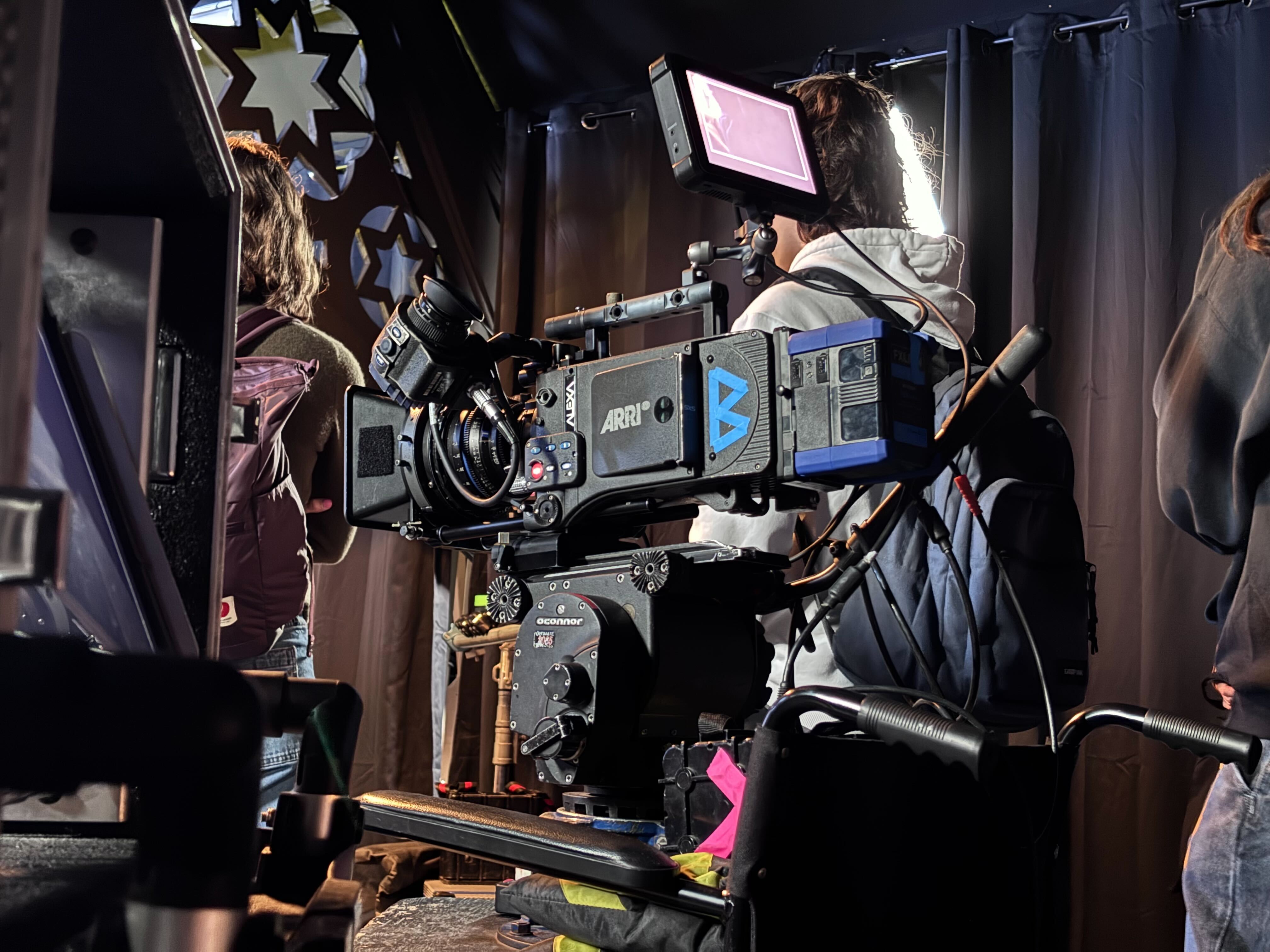 Student standing in front of Arri Alexa digital camera
